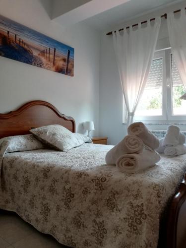 a bedroom with a bed with towels on it at Apartamentos casa enrique in Lires