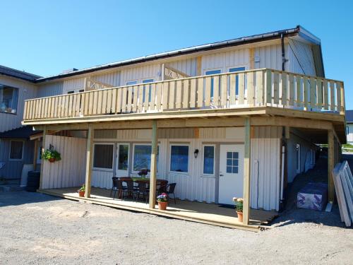 a large house with a deck on top of it at Hansnes Havfiske in Hansnes