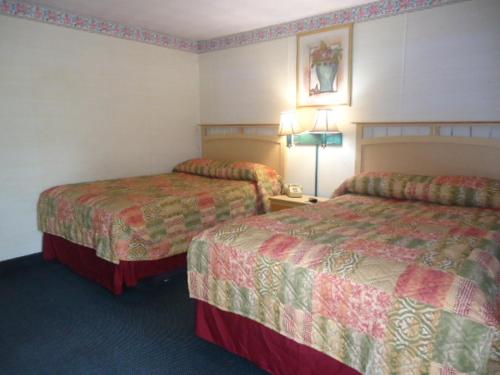 a hotel room with two beds in a room at Relax Inn in Fisherville