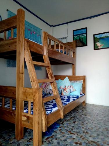 a bedroom with two bunk beds in a room at Bolo Beach Santorini nearby to Hundred Island in Alaminos