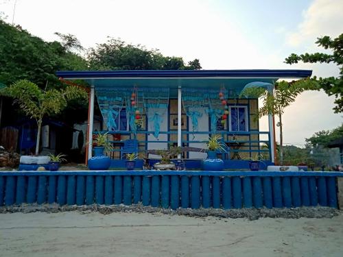 a blue building with a blue fence in front of it at Bolo Beach Santorini nearby to Hundred Island in Alaminos