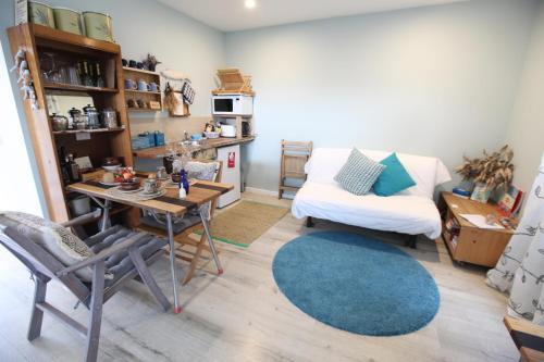 a living room with a table and a couch at Sea Salt Bnb in Rosebud
