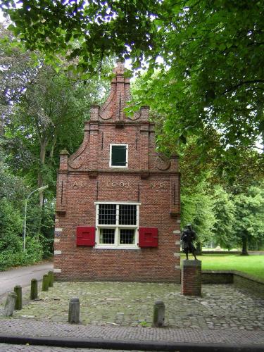 a brick building with a window in a park at Restaurant Hotel Merlet in Schoorl