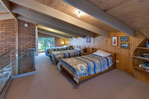 a room with two beds and a staircase in it at Getaway in Paynesville
