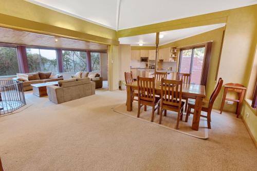 a dining room and living room with a table and chairs at Above Sunset in Paynesville