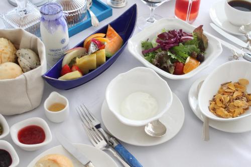 a white table with bowls of food on it at Hotel Limani in Setouchi