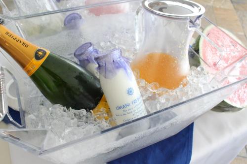 a plastic container with a bottle and a bottle of liquid at Hotel Limani in Setouchi