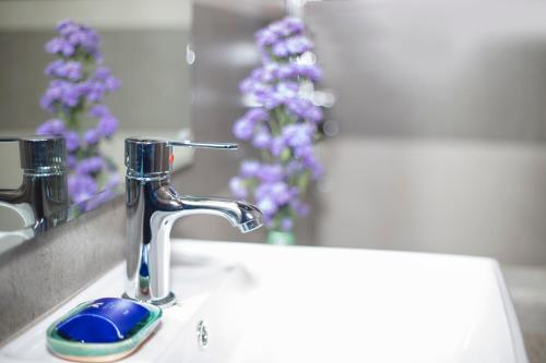 a bathroom sink with a faucet and a toothbrush at Amora Lagoon Hotel in Katunayake