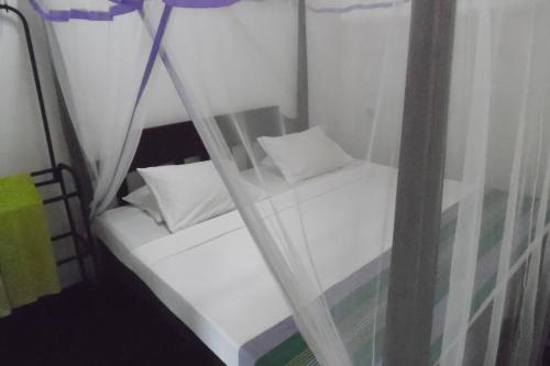 a small room with two white pillows and a window at Thalalla BnB in Talalla