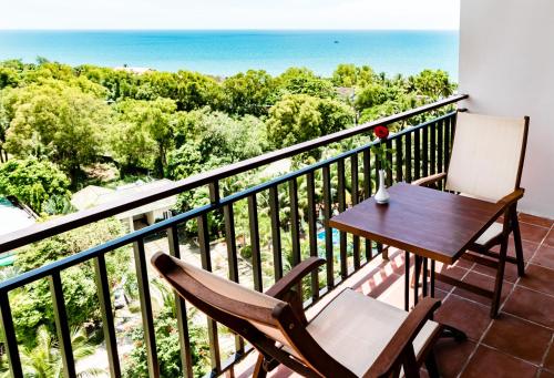 a balcony with a table and chairs and the ocean at Summer Dream Hotel in Phu Quoc