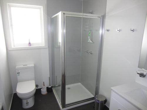 a bathroom with a shower and a toilet at Orford Escape in Orford