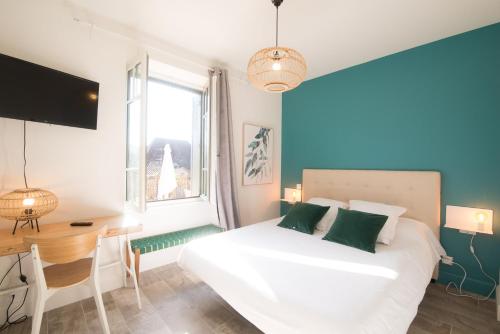 サルラ・ラ・カネダにあるLa Belle Terrasse avec climatisation et parking privéのベッドルーム1室(白いベッド1台、デスク、窓付)