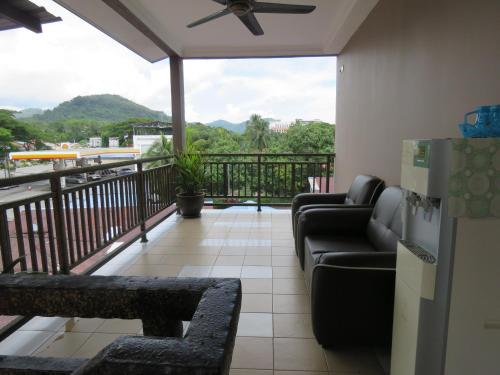 a living room with a couch and a balcony at Gm Motel in Kuah