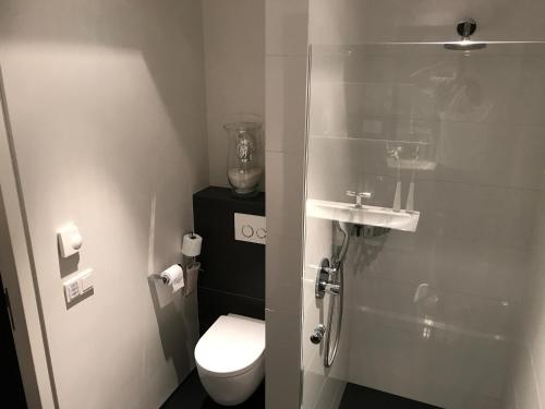 a small bathroom with a toilet and a sink at WK12 Suite in Cuijk
