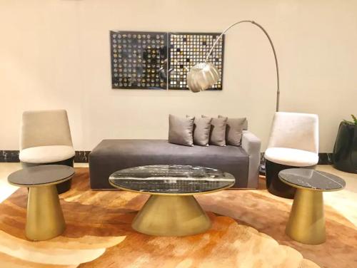 a living room with a couch and two tables at Mactan Newtown Cebu Affordable Suite! in Mactan