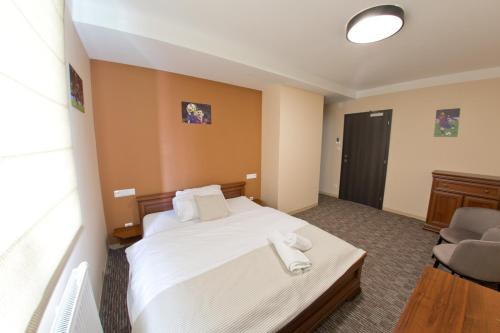 a hotel room with a bed and a chair at Reštaurácia GÓL in Veselé