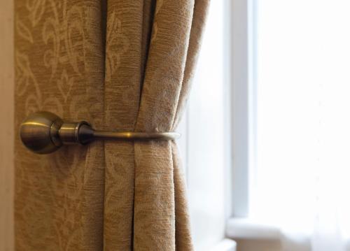 a curtain in a room with a window at Heather Glen Guest House in Elgin