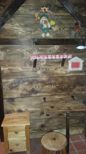 a wooden wall with a table and a stool at Chambres d'Hôtes Chalet de la Source in Morillon
