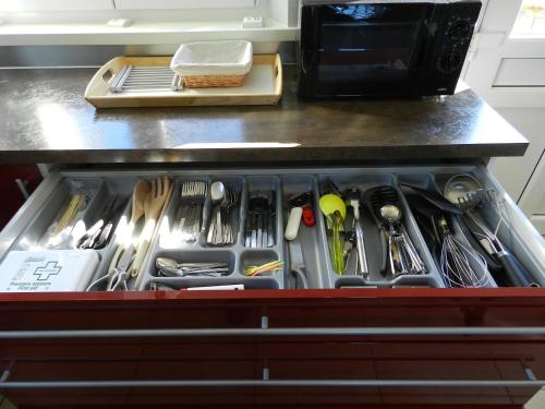 a drawer filled with utensils in a kitchen at Gîte La Grenouillère in Esquéhéries