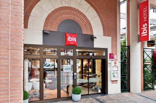 a store front with a job sign on the door at ibis Lille Centre Gares in Lille