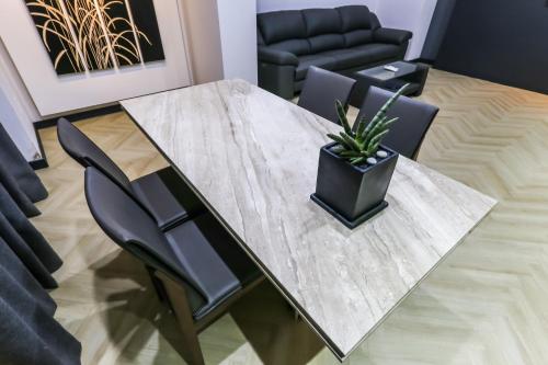 a dining room table with a potted plant on it at Seosan Aria Hotel in Seosan