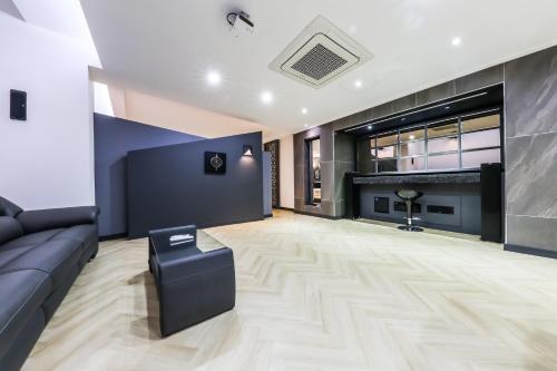 a living room with a couch and a fireplace at Seosan Aria Hotel in Seosan