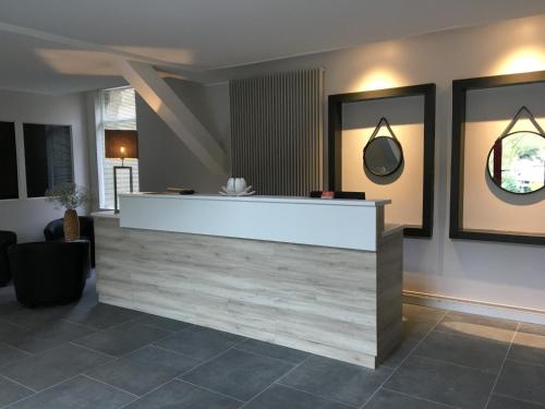 a lobby with a reception desk in a building at Domaine de Joinville in Eu