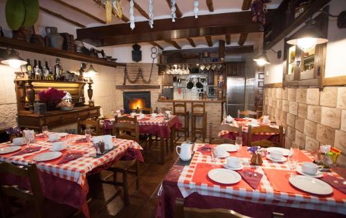 a restaurant with tables with red and white tablecloths at La Casa de Lucas in Clavijo