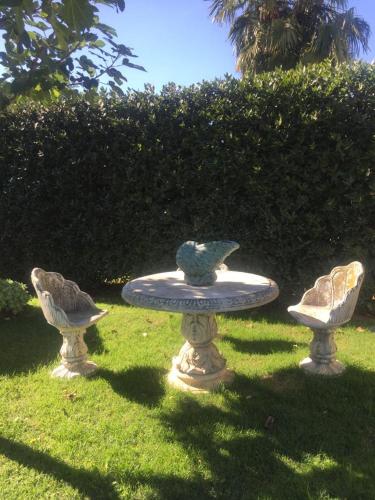 a fountain in the grass with two birds on it at La Pergola B&B in Cesena