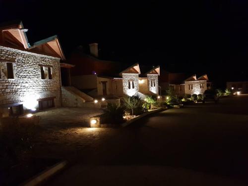 a group of houses lit up at night at Pallas Casa in Panagía