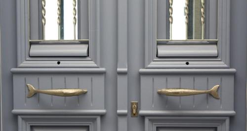 two doors with gold handles in front of a building at Villa Kardiani in Kardhianí