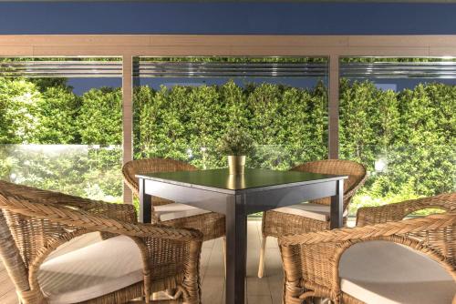 a dining room with a table and chairs and a large window at Inhouse Hotel Grand in Taichung