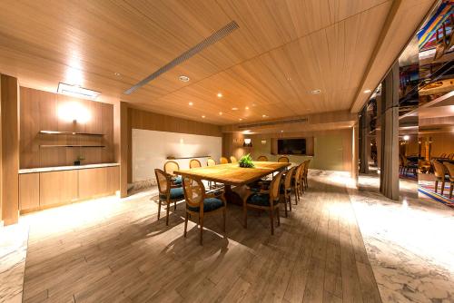 a dining room with a wooden table and chairs at Inhouse Hotel Grand in Taichung