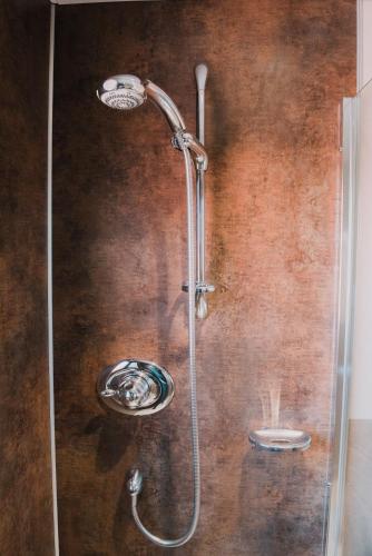 a shower with a glass door in a bathroom at Greenbank Bed & Breakfast in Montrose