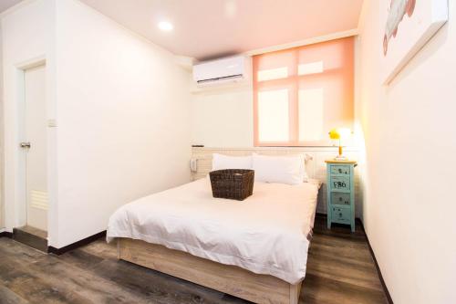 Cama o camas de una habitación en Meizhou Hot Spring Hotel溫泉商旅