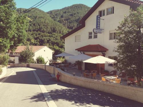 a inn with tables and umbrellas in front of it at Horizonte do Gerês in Geres