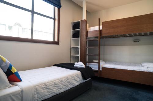 a bedroom with two bunk beds and a window at U Boutique Hotel in Wellington