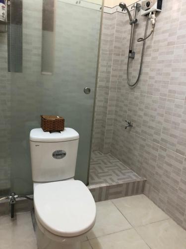 a bathroom with a toilet and a shower at Moon house tropical garden - West side in Nha Trang