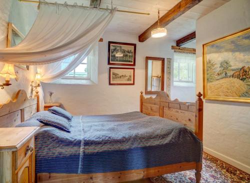 a bedroom with a bed with a blue comforter at Svostrup Kro in Silkeborg