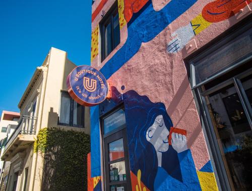 a building with a painting of a woman on it at U Boutique Hotel in Wellington
