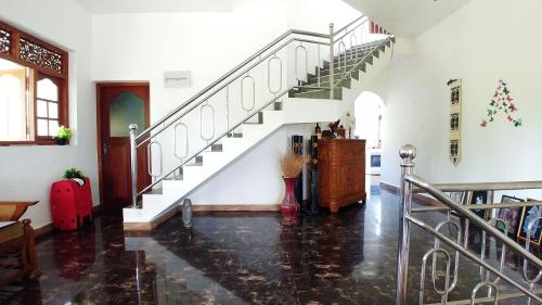 a hallway with a staircase in a house at Guest House Basilea in Beruwala