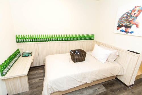 Cama o camas de una habitación en Meizhou Hot Spring Hotel溫泉商旅