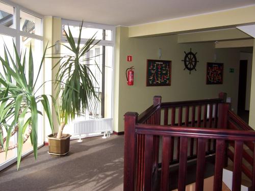 a room with a staircase and a potted plant at Willa Global komfortowe pokoje nad morzem in Jastrzębia Góra