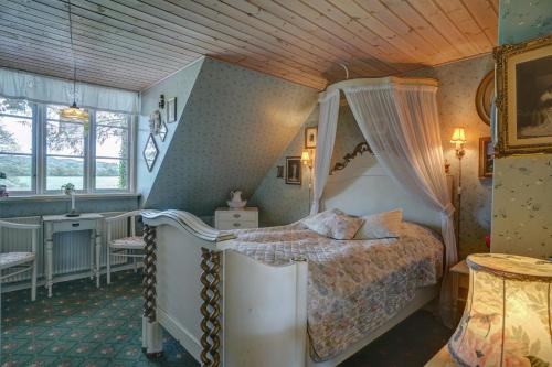 a bedroom with a bed with a canopy at Svostrup Kro in Silkeborg