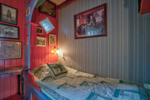 a bedroom with a bed in a red room at Svostrup Kro in Silkeborg