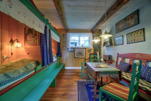 a bedroom with a bed and a table and chairs at Svostrup Kro in Silkeborg