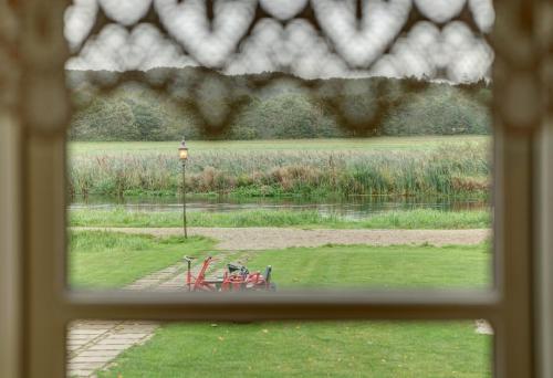 a window view of a park with a table and chairs at Svostrup Kro in Silkeborg