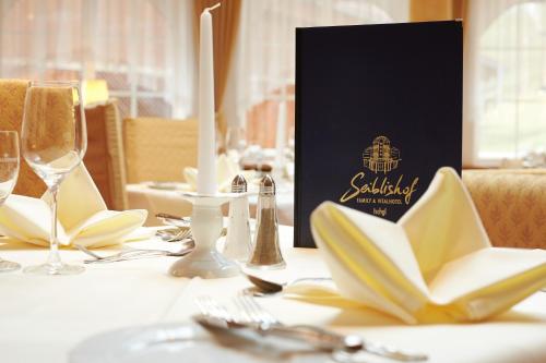 a table with glasses and silverware on a table at Seiblishof Superior Hotel Ischgl in Ischgl