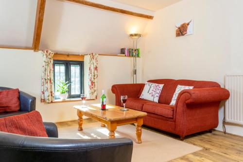 a living room with two couches and a coffee table at Puddleduck Valley in Holsworthy