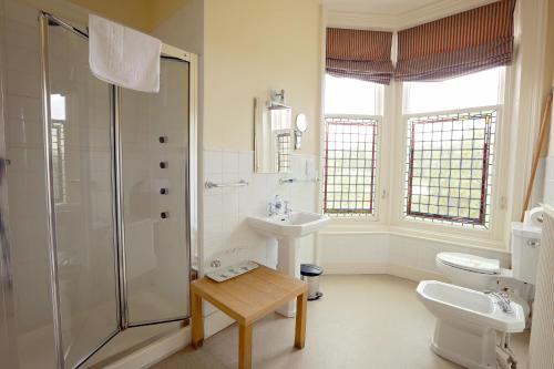 a bathroom with a shower and a sink and a toilet at Kingsknowes Hotel in Galashiels